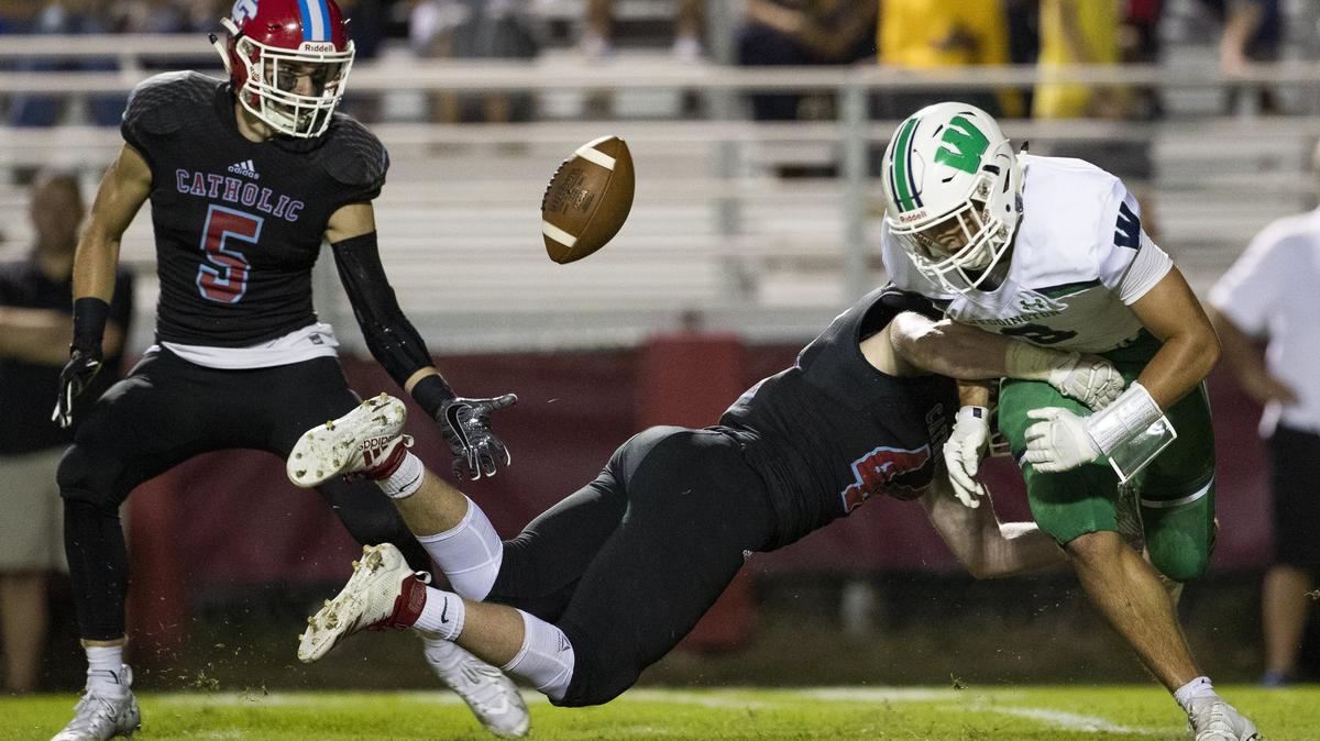 Charlotte Catholic Liam Barbee (center) causes Weddington’s Elijah Pettway to fumble during a prep football game at Charlotte Catholic High School Friday, September 28, 2018 in Charlotte, NC. Photo by JASON E. MICZEK - Special to the Observer