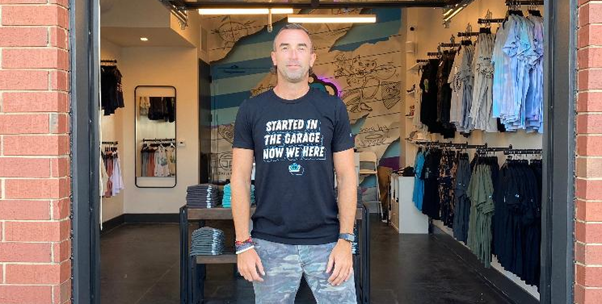 Glory Days Apparel owner JD Harris waits to greet his customers at the grand opening of his new store in South End.