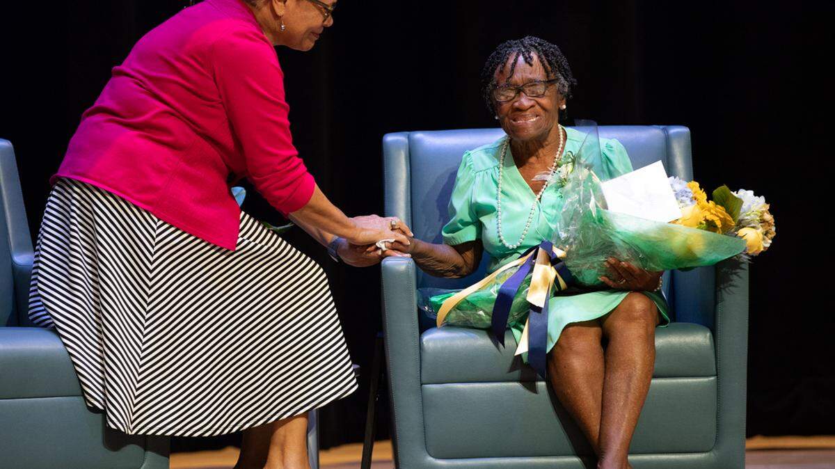 Mayor Vi Lyles, left, declared Aug. 25 “Miss Betty Day” in Charlotte, honoring longtime employee Betty Davis, right, at Queens University.