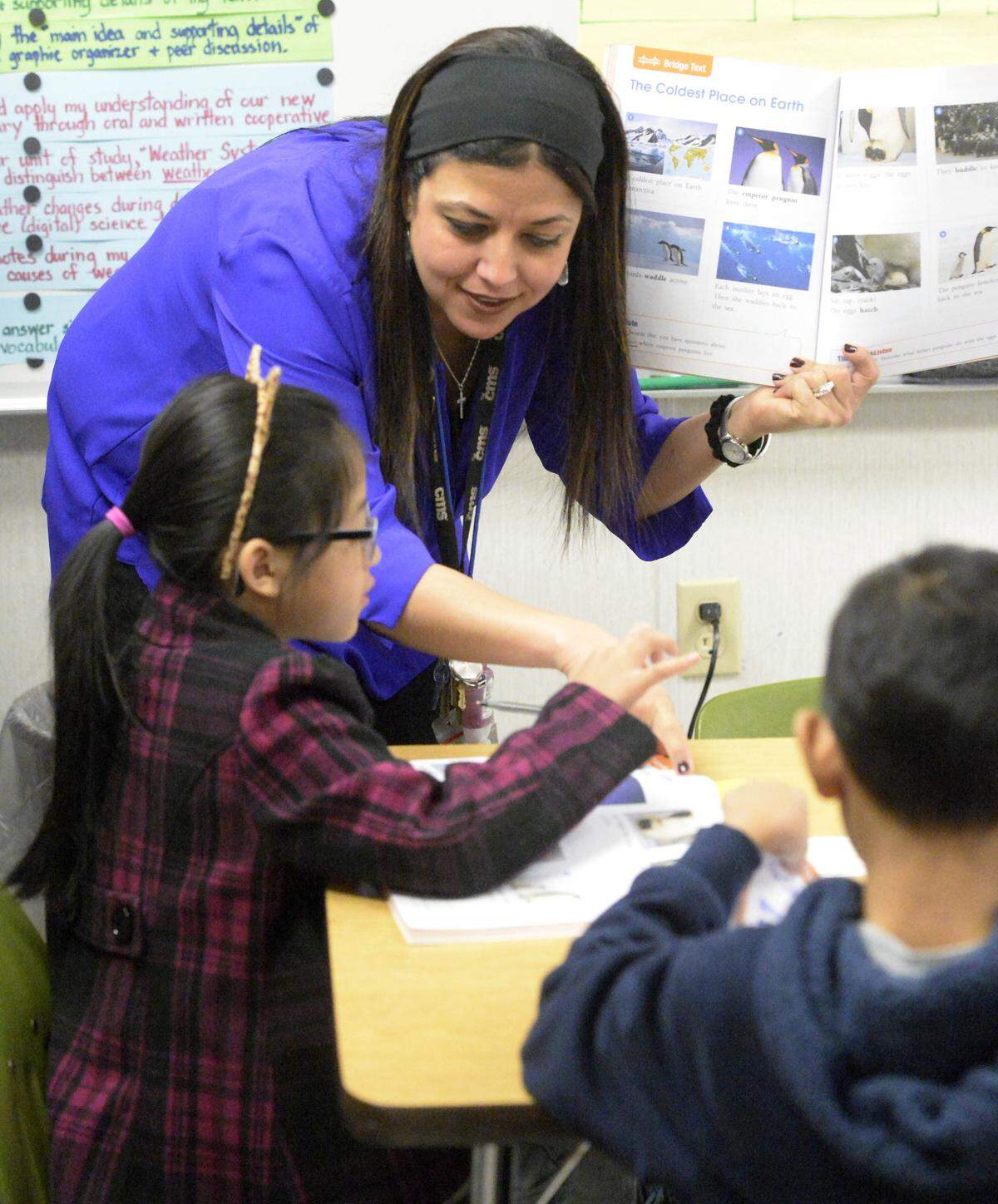 Camille Bourguignon, an English as a second language teacher at Reedy Creek Elementary, works with Mary Khintintling, a second grader, with a lesson on Monday, January 14, 2019. For the first time ever, Charlotte-Mecklenburg Schools has more than 20,000 immigrant students who need help learning English.