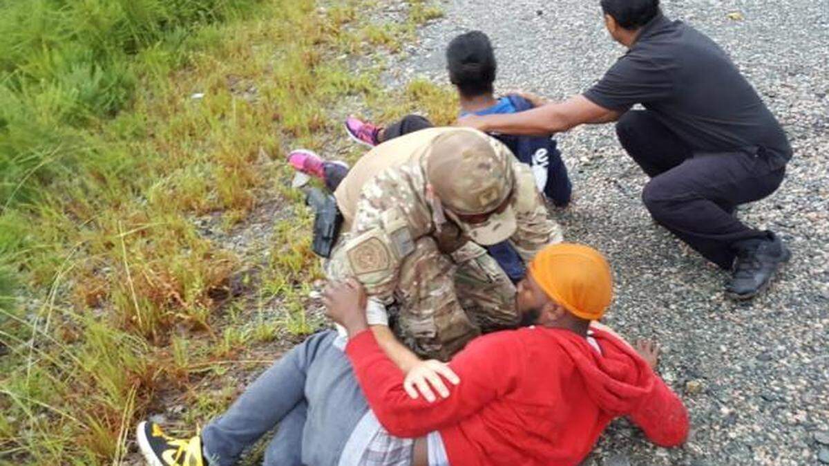 Three U.S. border patrol agents were helping with Florence relief in Morrisville, NC, when they chanced upon a wrecked car in a field and helped tend to three injured people. In this picture, two of the victims are ‘conscious’ as the agents help them, according to a U.S. Customs and Border Protection news release.
