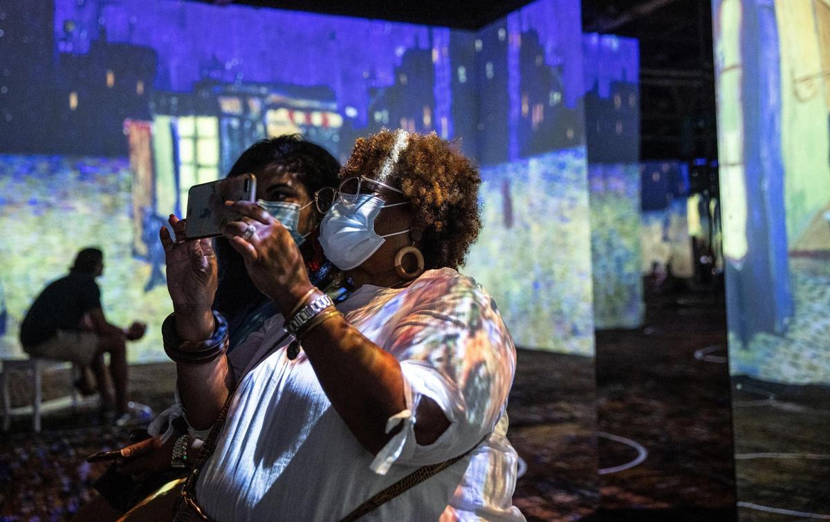 Sydney Neely, left, and her mom, Cheryl watch the new Immersive Van Gogh Exhibit in Charlotte, N.C., on Thursday, June 17, 2021. Sydney surprised her mom with tickets to the event for mother’s day. Knikouyeh@charlotteobserver.com