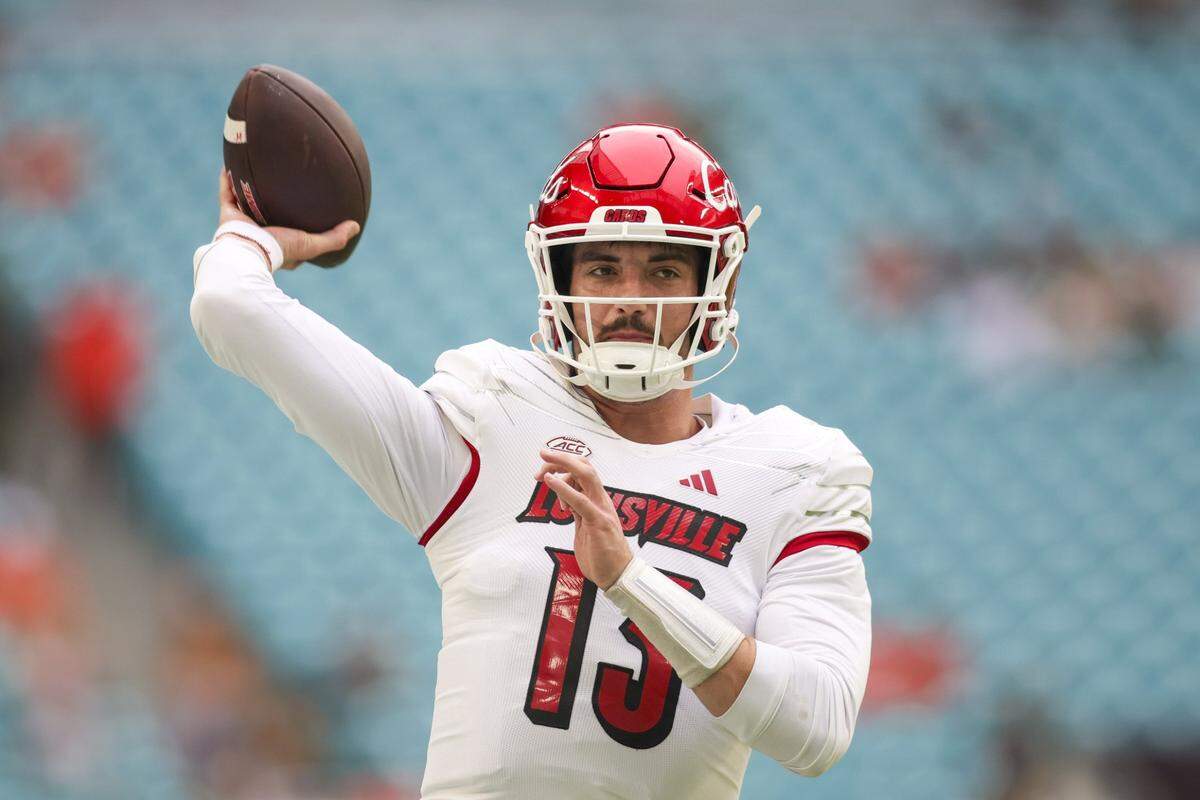 Nov 18, 2023; Miami Gardens, Florida, USA; Louisville Cardinals quarterback Jack Plummer (13) throws the football prior to the game against the Miami Hurricanes at Hard Rock Stadium. Mandatory Credit: Sam Navarro-USA TODAY Sports
