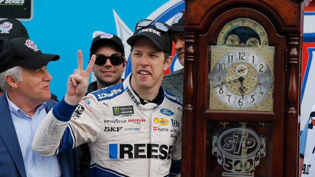 Brad Keselowski celebrates with the grandfather clock trophy Sunday after winning a lackluster NASCAR Cup Series race at Martinsville Speedway.