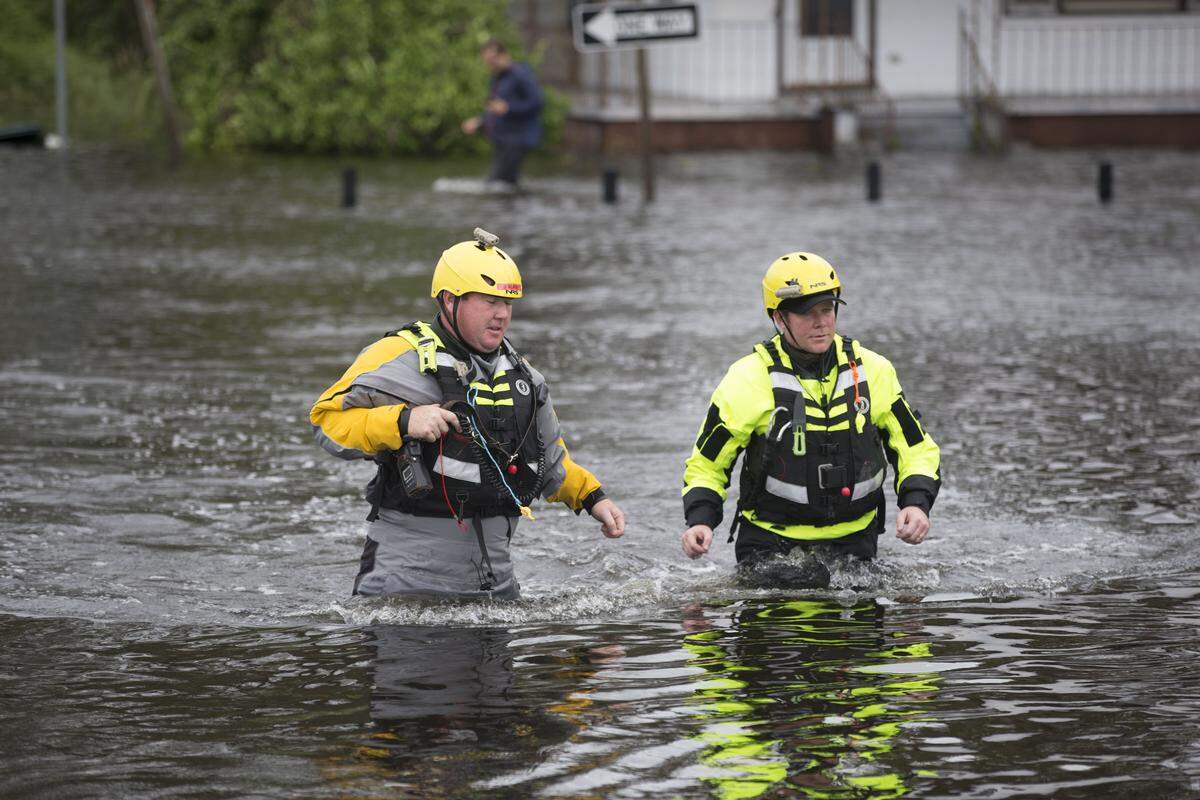 Members of the Greenville Fire Department swift water team go house to house following Hurricane Florence checking flooded homes along Cedar Street on Saturday morning September 15, 2018 in New Bern, N.C.