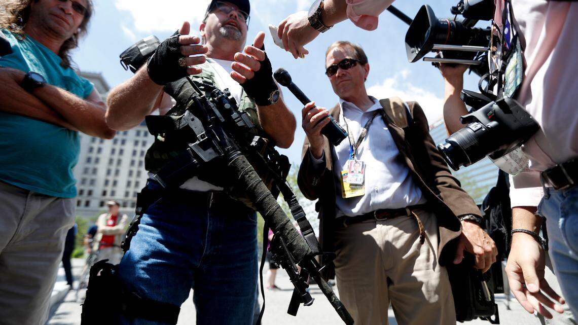 Second Amendment supporter Steve Thacker carries an AR-15-style weapon as he talks to the media during a protest on Sunday, July 17, 2016, in Cleveland.