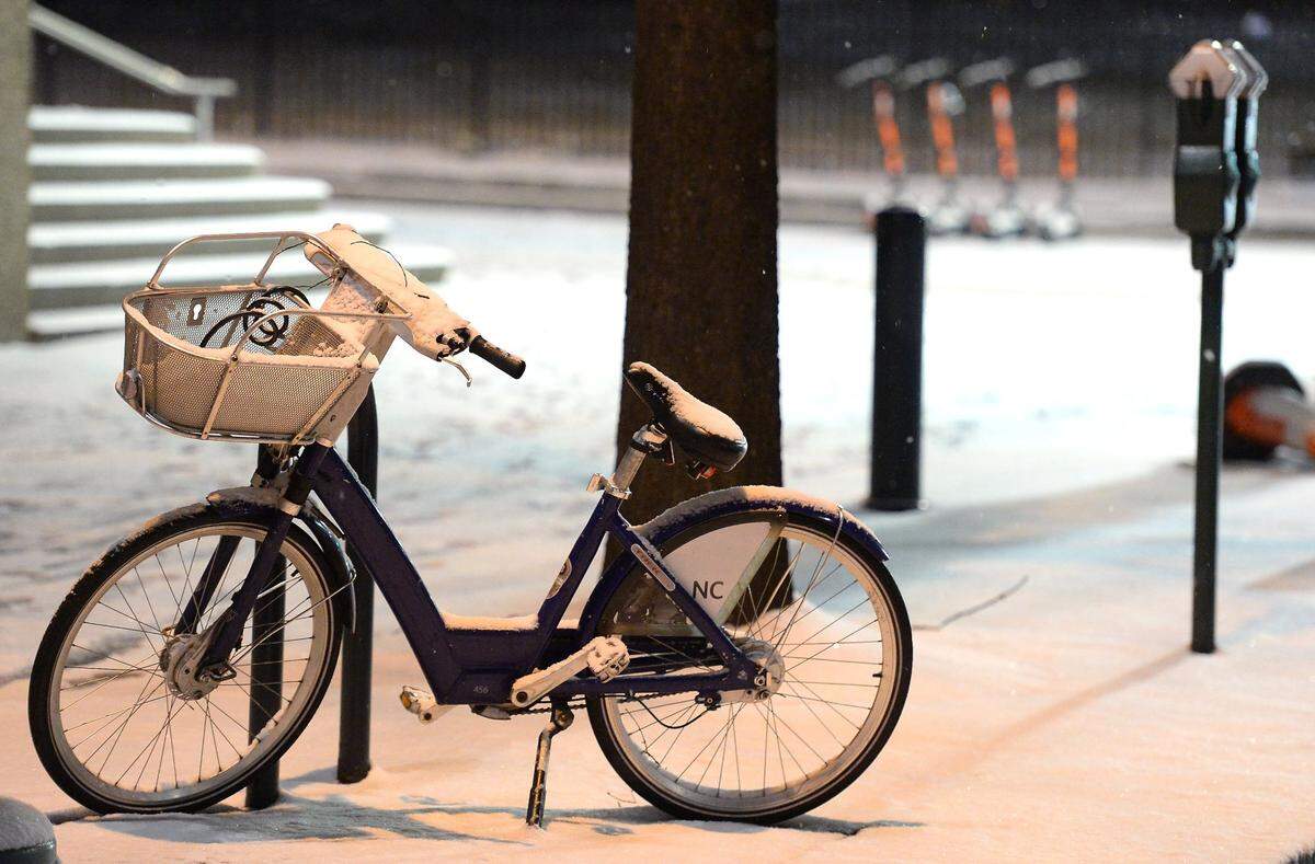 A snow covered bicycle stands along N. Tryon St. in uptown Charlotte in January 2022.