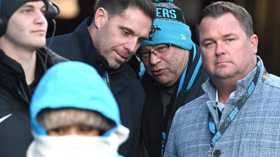 Carolina Panthers assistant general manager Dan Morgan, left, speaks with team owner David Tepper, right, during a 2022 game. At right is general manager Scott Fitterer.