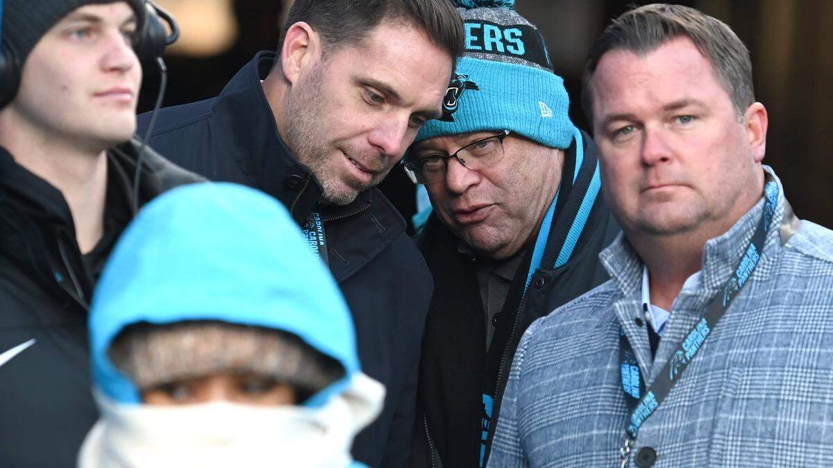Carolina Panthers assistant general manager Dan Morgan, left, speaks with team owner David Tepper, right, during a 2022 game. At right is general manager Scott Fitterer.
