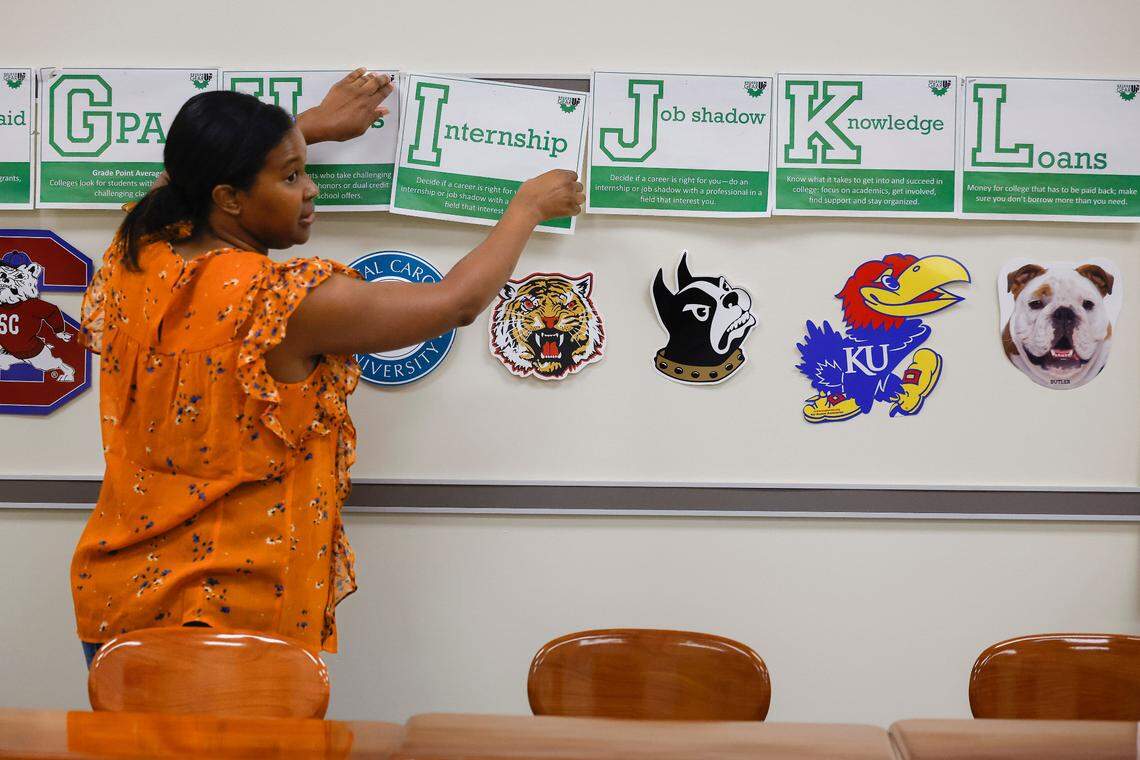 CTE teacher Carita Evans, of Charlotte, N.C.,works to decorate her classroom at West Charlotte High School in Charlotte, N.C., Friday, Aug. 26, 2022.