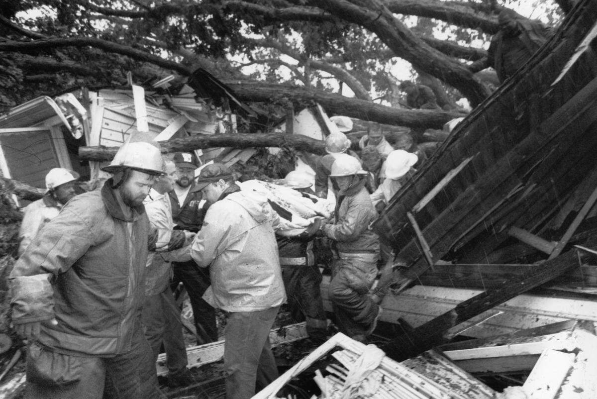9.22.1989: Rescuers bring out Tammie Bridges, 24, who was trapped in her home for two hours, after a tree fell on her house. She hid in her closet on Virginia Ave. in Bessemer.