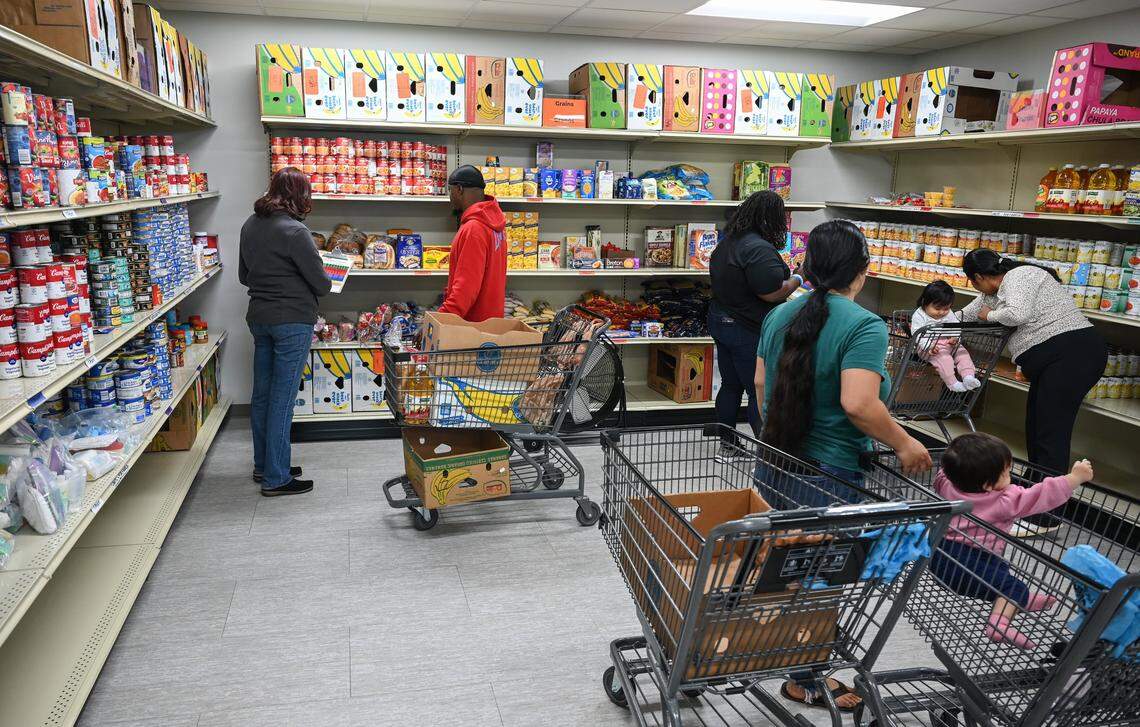 People shop at the pantry inside at Care Ring on Plymouth Avenue in Charlotte, NC on Thursday, October 31, 2025. Care Ring is a nonprofit organization dedicated to providing health services for the uninsured, underinsured or those lacking access to affordable, high-quality health care through its Care Ring Clinic and Physicians Reach Out network.
