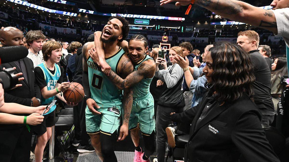 Charlotte Hornets forward Miles Bridges, left, is hugged by guard Nick Smith Jr., right, after Bridges hit the game winning basket to defeat the San Antonio Spurs 117-116 at Spectrum Center in Charlotte, NC on Friday, February 7, 2025.