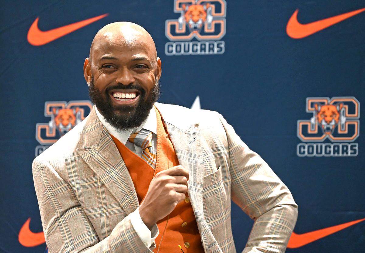 Former Carolina Panthers cornerback Captain Munnerlyn smiles as he responds to questions after being introduced as the new head football coach at Julius Chambers High School in Charlotte, NC on Friday, January 24, 2025.
