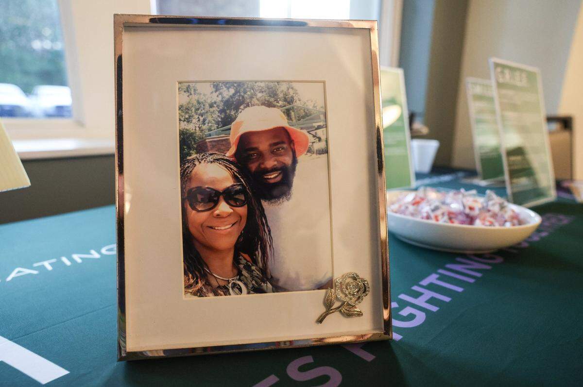 On a table sits a framed photo of Tina Sykes-Mosley and her son, Marcus Gerard Mosley, who she lost to gun violence on Thursday, May 15, 2025. A few years after her son’s death, Sykes-Mosley founded a support group for fellow mothers who have lost a child to homicide.