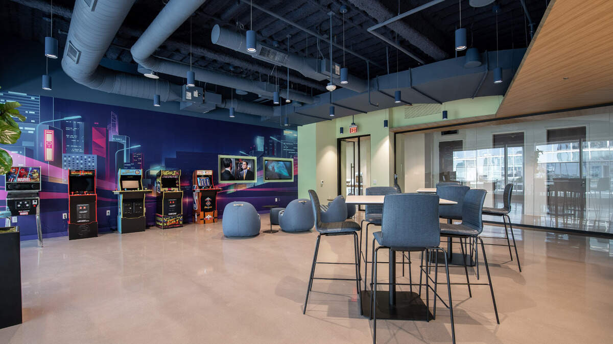 Armstrong Transport Group’s new headquarters at Vantage South End in Charlotte includes a game room with classic video games, pinball and tabletop shuffleboard