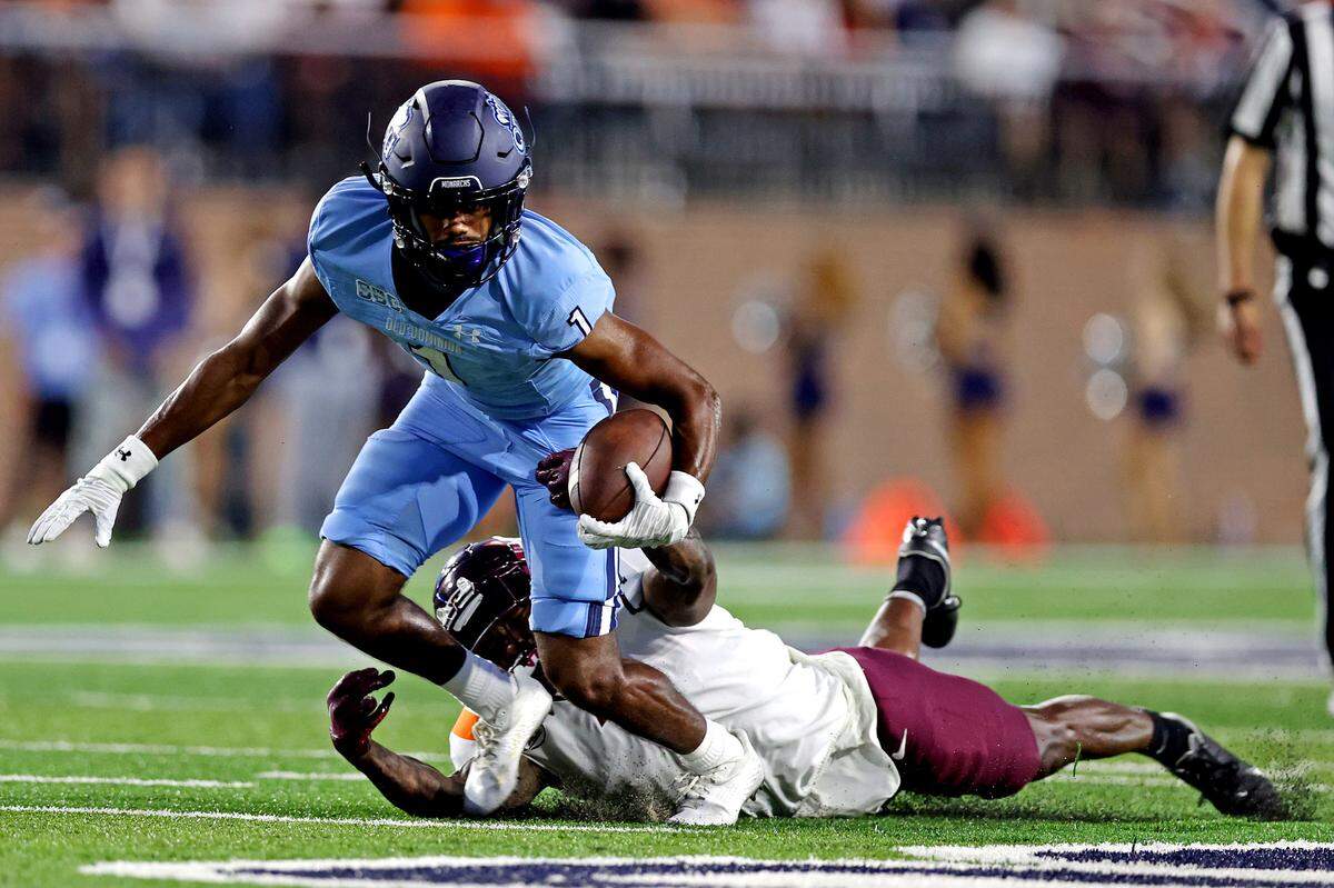 Old Dominion Monarchs wide receiver Jordan Bly (1) runs the ball against Virginia Tech Hokies defensive back Chamarri Conner (1) during the second quarter at Kornblau Field at S.B. Ballard Stadium.