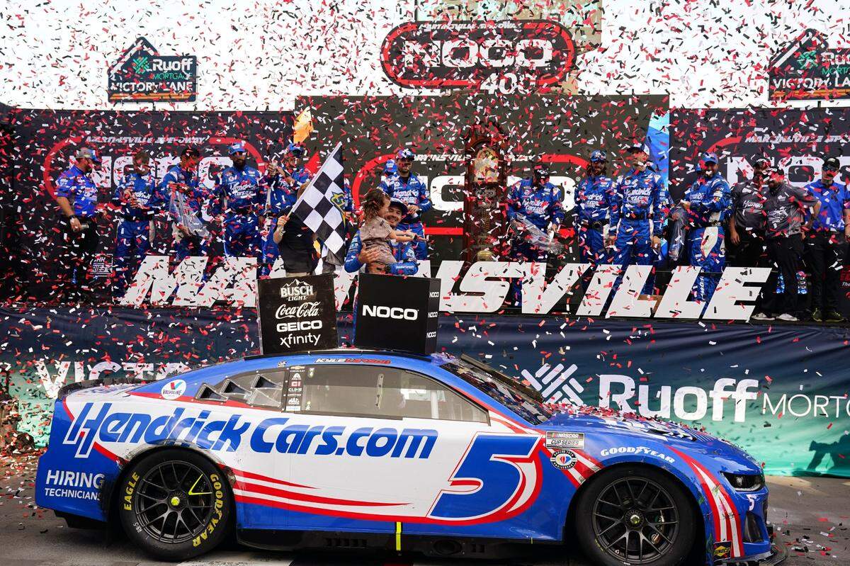 Apr 16, 2023; Martinsville, Virginia, USA; NASCAR Cup Series driver Kyle Larson (5) celebrates in victory lane with his children Owen Larson and Audrey Layne Larson after winning the NOCO 400 at Martinsville Speedway. Mandatory Credit: John David Mercer-USA TODAY Sports