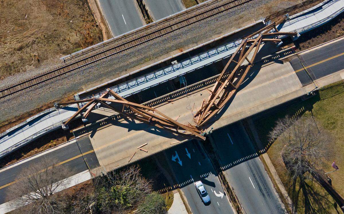 This aerial image taken with a drone, shows the collapsed wooden arches in Hickory, NC, on Friday morning, Feb. 18, 2022. The arches are an artistic component of a pedestrian bridge named for former Hickory Mayor Wright, which itself is part of the City Walk.