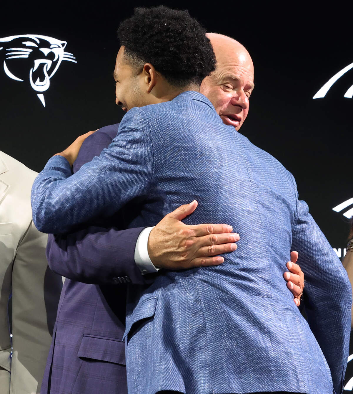 Carolina Panthers owner David Tepper, left and quarterback Bryce Young, right, hug following a fireside chat on Thursday, July 23, 2026.