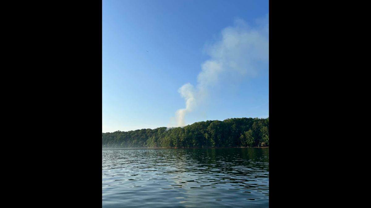 Much to the surprise of firefighters, a fire thought to have been doused earlier this week by thunderstorms continued to burn on a Lake Norman island Thursday, June 16, 2022.