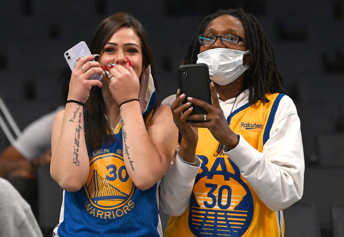 Fans gush as Golden State Warriors guard Stephen Curry takes the Spectrum Center court in Charlotte Sunday.