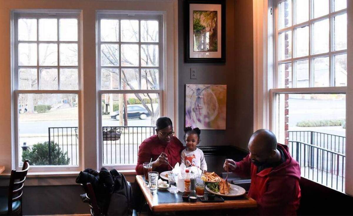 Shana Boney (pronounced Bone A), Chloe Boney, 1, and Anthony Boney visit the Cajun Queen restaurant on 7th Street.