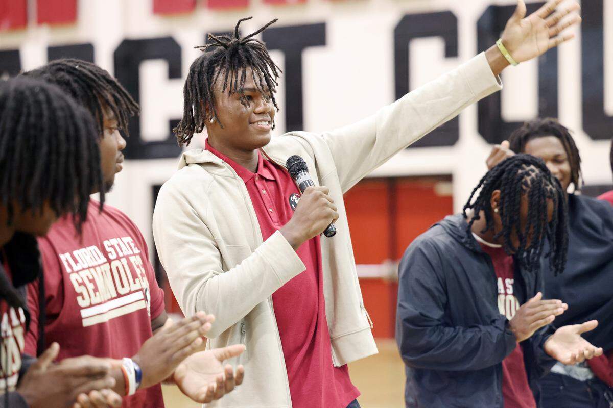 Malik Clark, a wide receiver at Rock Hill High School gestures to a crowd Thursday after signing day at the school. Clark will play for Florida State University. The senior four-star wideout is rated as the state’s top receiver and No. 2 overall high school football recruit by 247Sports.