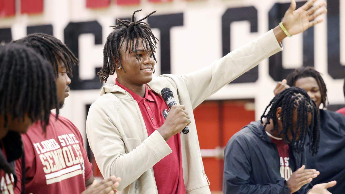 Malik Clark, a wide receiver at Rock Hill High School gestures to a crowd Thursday after signing day at the school. Clark will play for Florida State University. The senior four-star wideout is rated as the state’s top receiver and No. 2 overall high school football recruit by 247Sports.