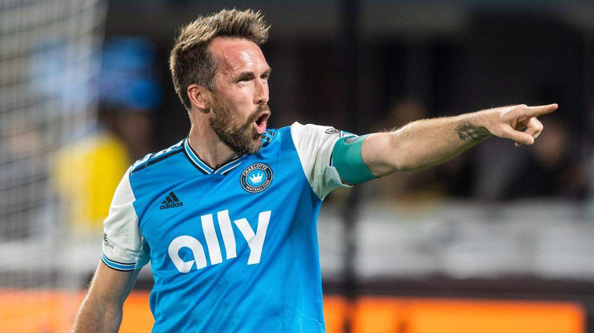 Charlotte FCs Christian Fuchs points to the fans in celebration after a win against the New England Revolution at Bank of America Stadium on Saturday, March 19, 2022 in Charlotte, NC. Charlotte FC defeated the Revolution, 3-1, for their first win of the season.