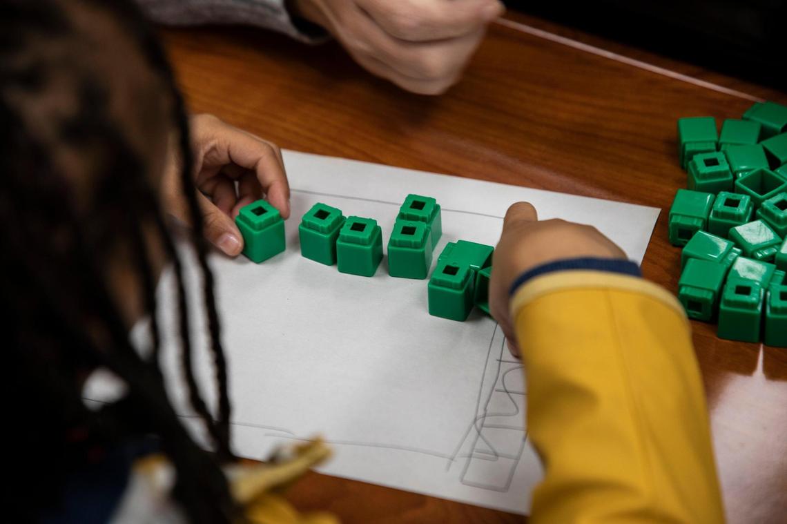 A student at Lansdowne Elementary calculates how many students are on a bus with blocks in a Heart Math tutoring session on Wednesday, Nov. 9, in Charlotte, NC. State Superintendent Catherine Truitt wants to “reform” how math is taught in North Carolina public schools.