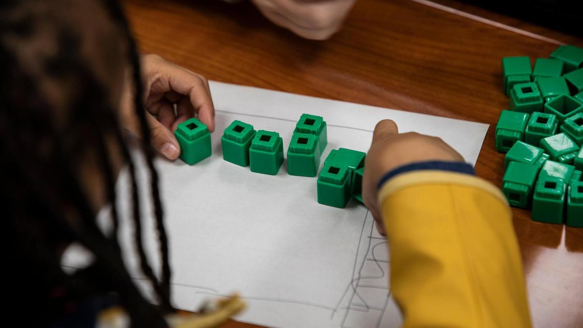 A student at Lansdowne Elementary calculates how many students are on a bus with blocks in a Heart Math tutoring session on Wednesday, Nov. 9, in Charlotte, NC. State Superintendent Catherine Truitt wants to “reform” how math is taught in North Carolina public schools.