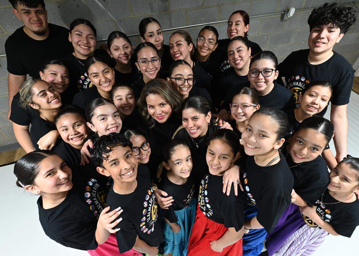 El Alma de la Luna co-directors Selene Pringle, center left, and Alma Campuzano, center right, with members of the troupe. The students not only learn to move to the music’s rhythm but also immerse themselves in an experience that fosters a connection with their cultural heritage, the development of social skills and creative expression. 