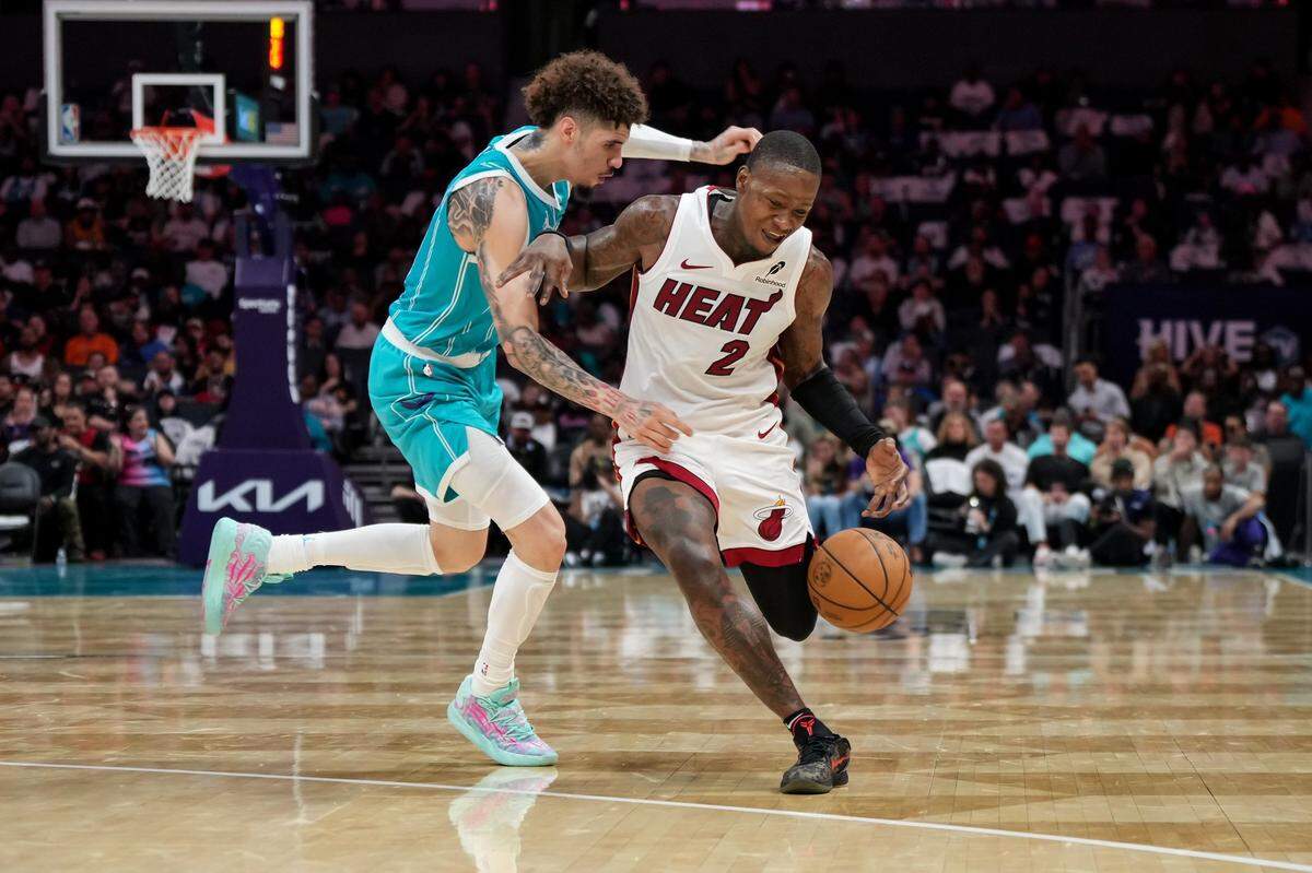Charlotte Hornets guard LaMelo Ball (1) defends Miami Heat guard Terry Rozier (2) during the second half of an NBA basketball game, Saturday, Oct. 26, 2024, in Charlotte, N.C. Matt Kelley / For The Observer