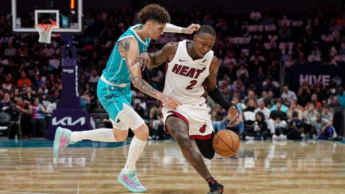 Charlotte Hornets guard LaMelo Ball (1) defends Miami Heat guard Terry Rozier (2) during the second half of an NBA basketball game, Saturday, Oct. 26, 2024, in Charlotte, N.C. Matt Kelley / For The Observer