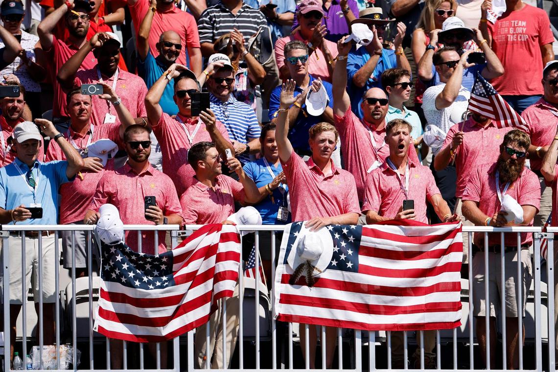Fans cheer as golfers make their way to the first tee during the Presidents Cup golf tournament at the Quail Hollow Club in Charlotte, N.C., Thursday, Sept. 22, 2022.