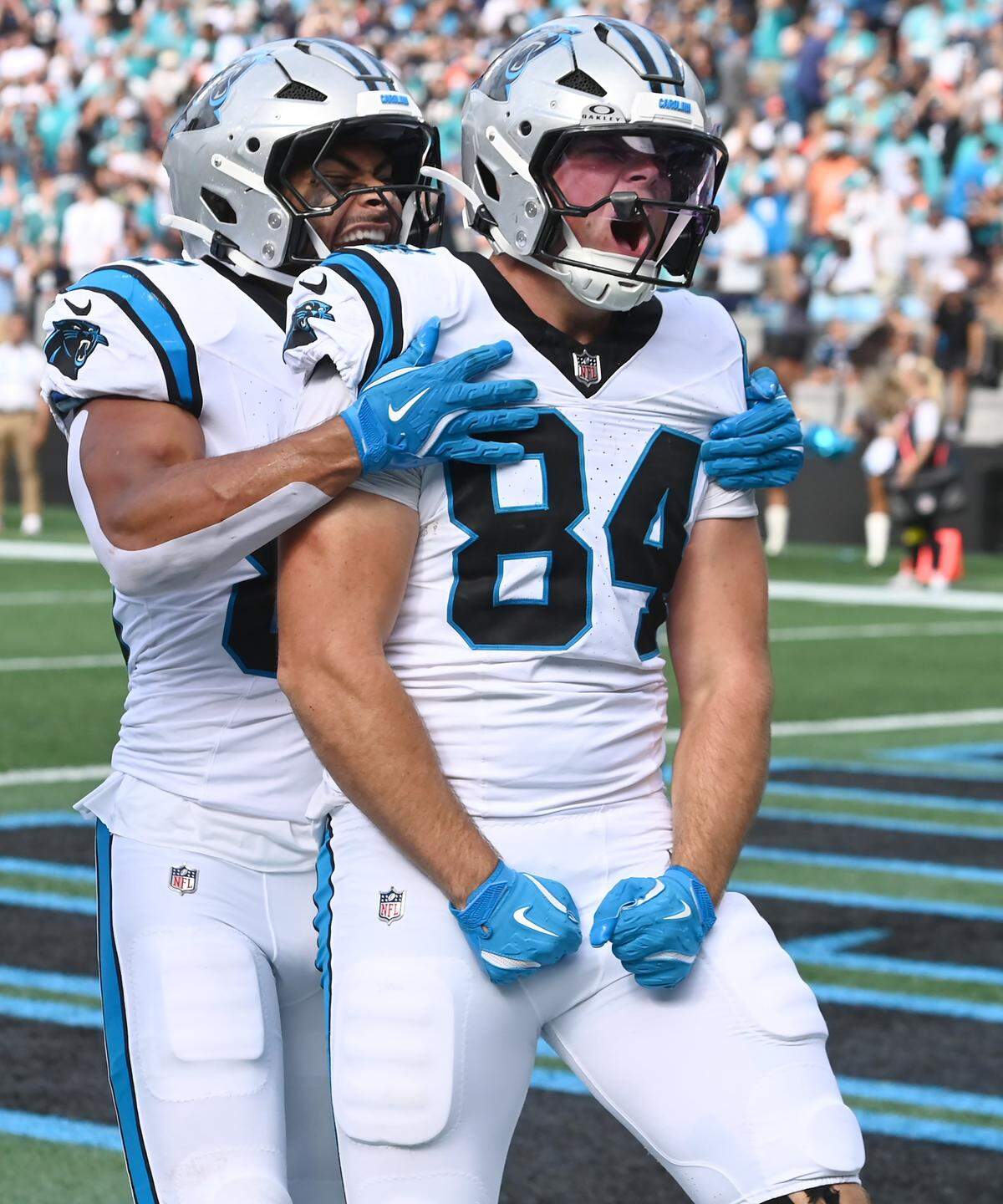 Carolina Panthers tight end Mitchell Evans, right, flexes as he celebrates his touchdown pass reception with his teammates during fourth quarter action against the Miami Dolphins on Sunday, October 5, 2025 at Bank of America Stadium in Charlotte, NC. The Panthers defeated the Dolphins 27-24.