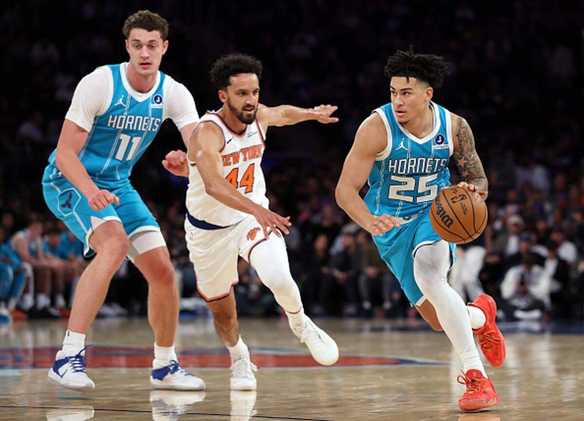 KJ Simpson of the Charlotte Hornets dribbles as Landry Shamet of the New York Knicks defends during the first half at Madison Square Garden in New York City.