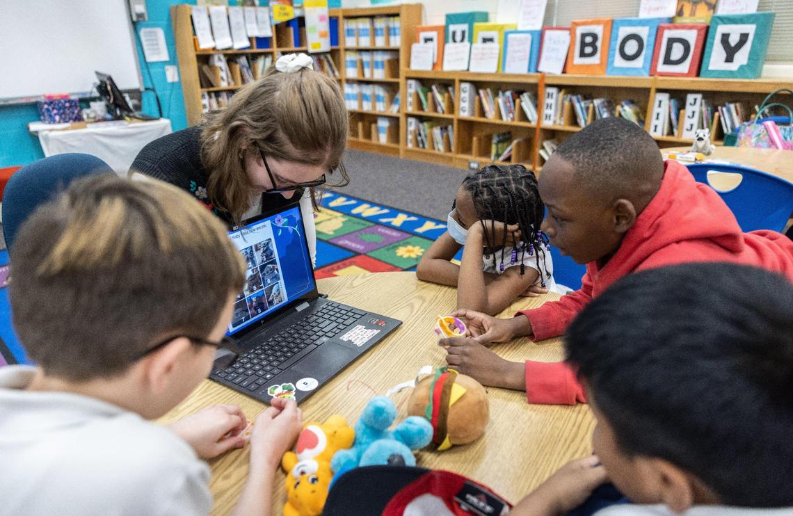 Ariel Spencer, left, tutors a group of students at Joseph W. Grier Academy in Charlotte, N.C., on Thursday, March 9, 2023.