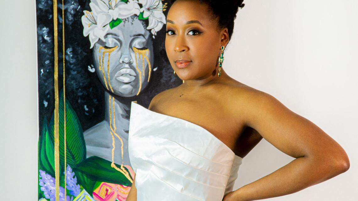 Artist Teresa Hopson in front of one panel in her series, “They that Sow the Tears,” which she said is representative of beauty being birthed from pain.