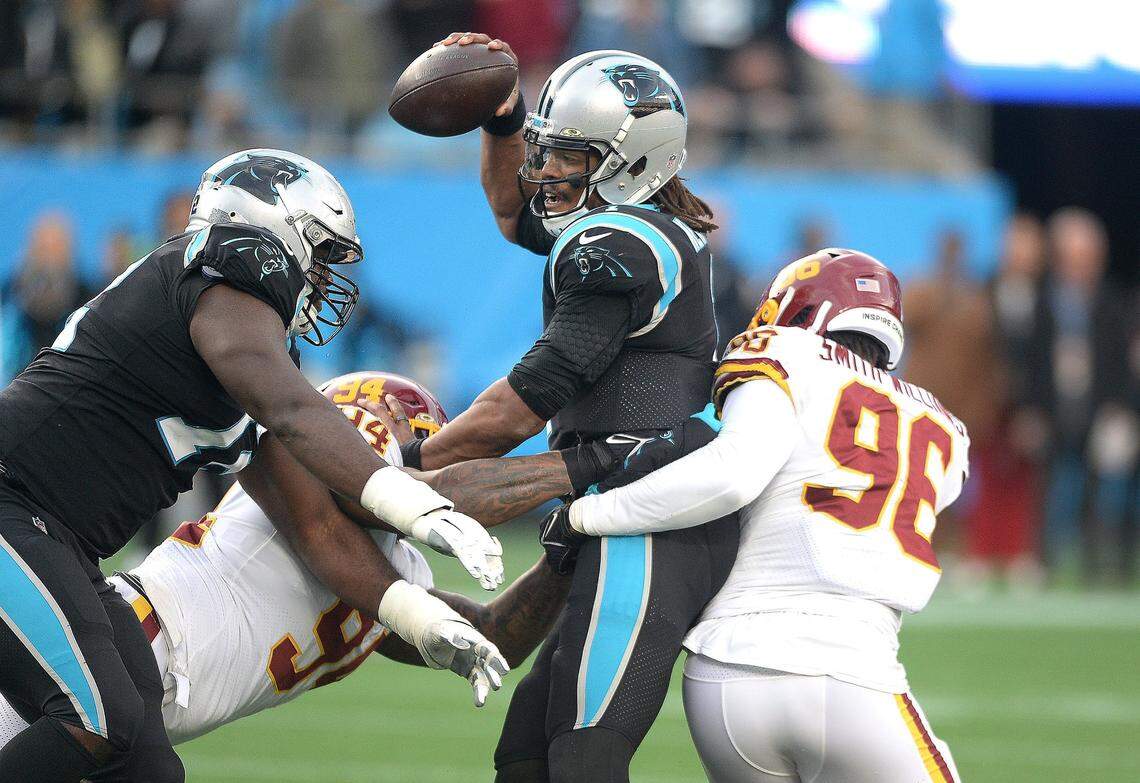 Carolina Panthers quarterback Cam Newton is sacked by Washington’s Daron Payne, left and defensive end James Smith-Williams in the closing moments of the game at Bank of America Stadium in Charlotte on Sunday. The Panthers lost, 27-21.