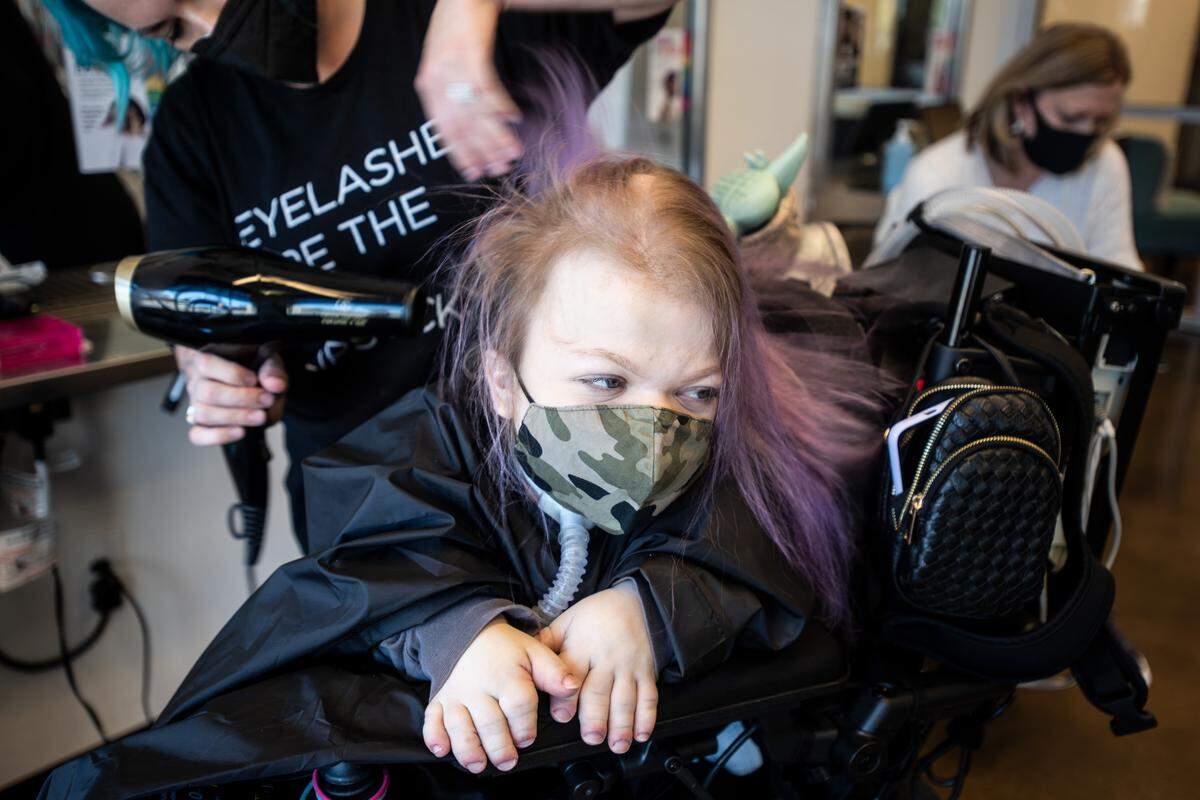 “We try to treat her like she’s older. Like, she’s 21, so she wants to have purple hair, I’ll let her have purple hair,” Lisa says of Abby, photographed earlier this spring getting purple streaks at Aveda Arts & Sciences Institute in Charlotte.