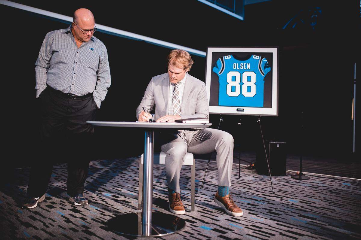 Carolina Panthers owner David Tepper and tight end Greg Olsen as he signs a one-day contract to retire as a Panther.
