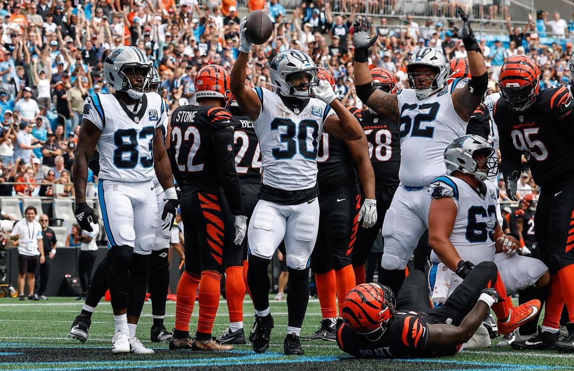 Panthers runningback Chuba Hubbard, center, raises the ball after scoring a touchdown during the game against the Bengals at Bank of America stadium in Charlotte, NC on Sunday, September 29, 2024.
