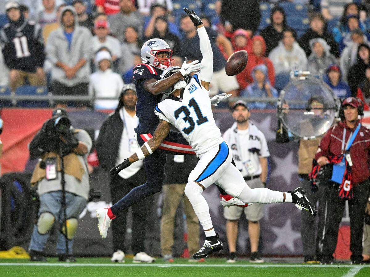 New England Patriots wide receiver Tyquan Thornton (11) and Carolina Panthers cornerback Lamar Jackson (31) battle for the ball during Thursday’s first half at Gillette Stadium. New England won, 17-3.