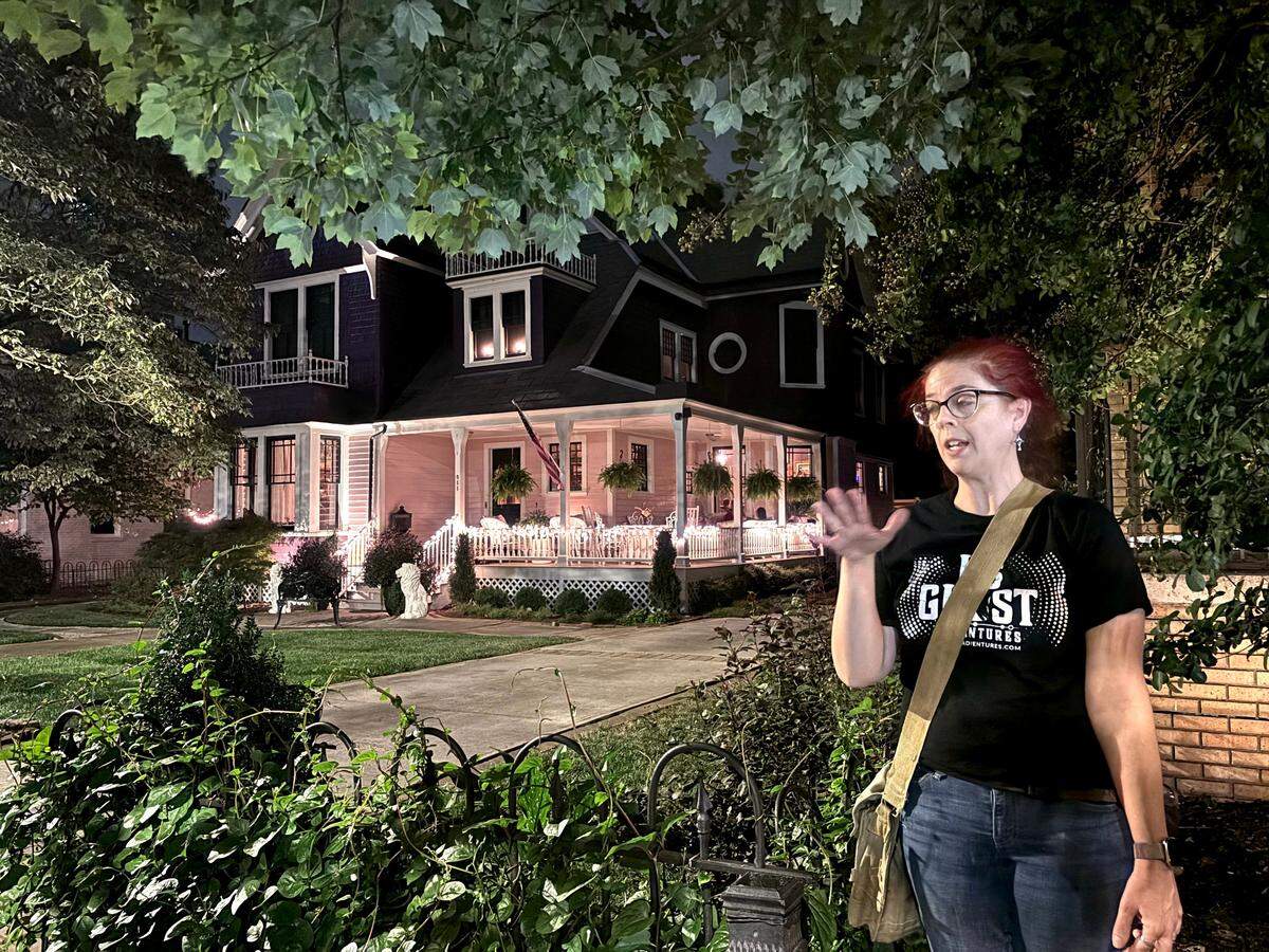Queen City Ghost Tours guide Amanda Caines tells a ghost story about McNinch House restaurant in Charlotte.