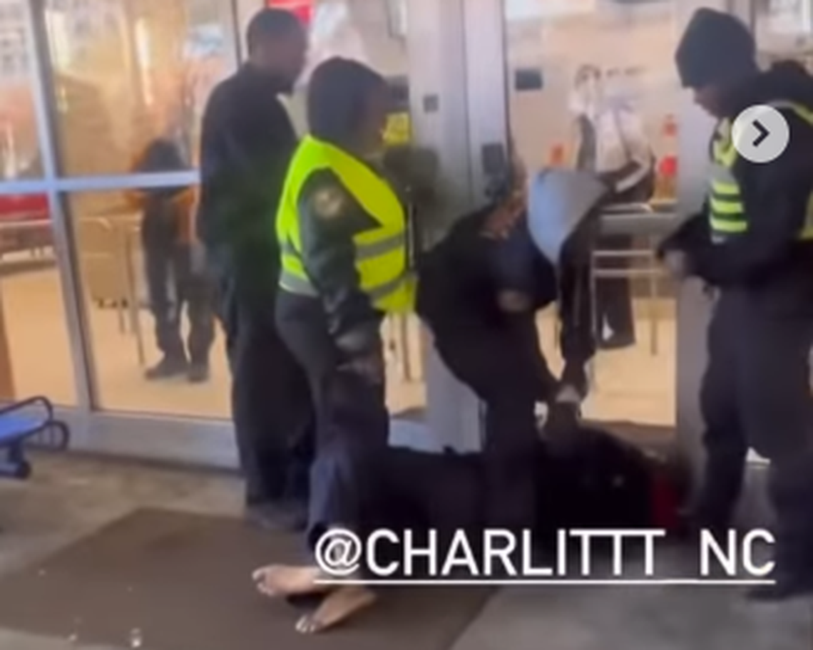 A frame from video posted to the Instagram account @charlittt_nc shows security guards arresting a man at the Charlotte Transportation Center on Sunday. The man died, according to CMPD.