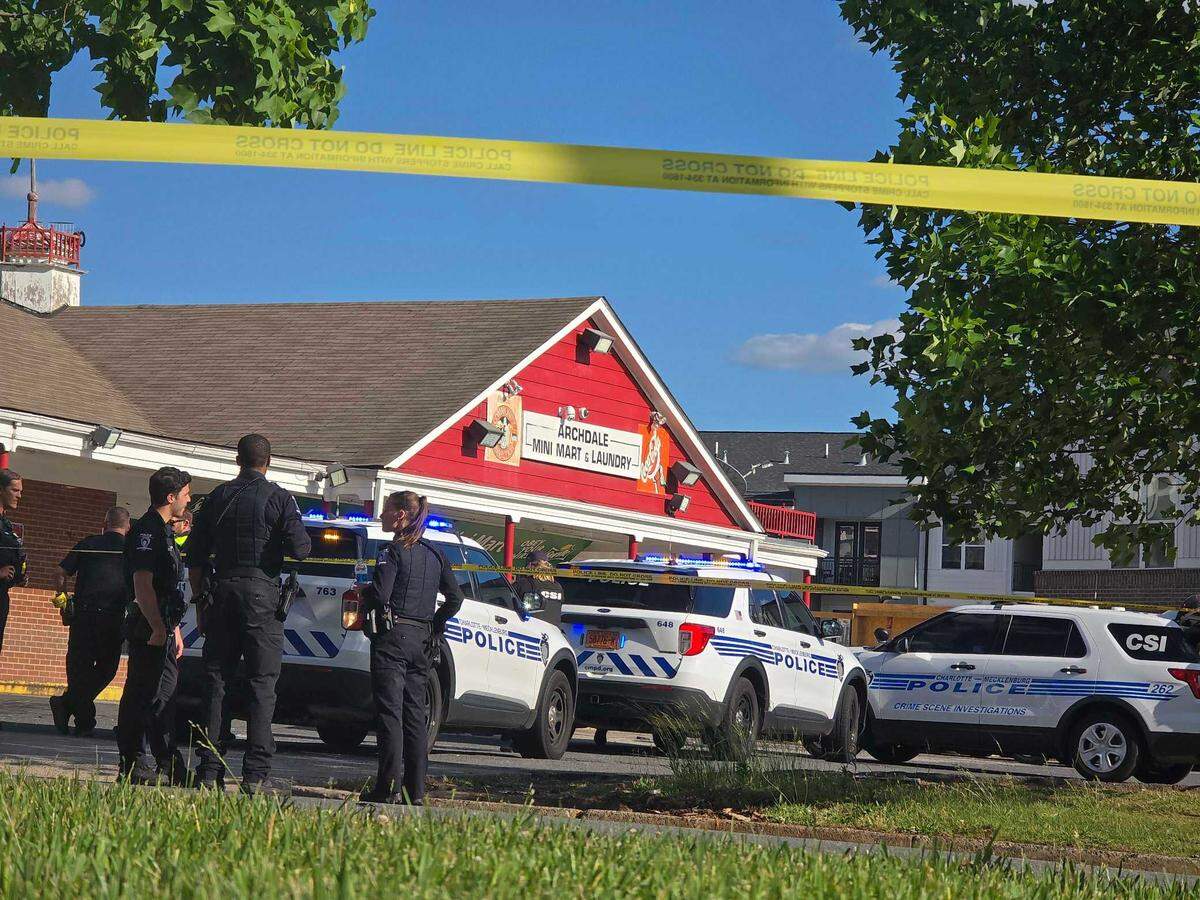 Police work the scene of a shooting at Archdale Minimart & Laundry on Monday afternoon, May 5, 2025. Four people shot, one deceased at the scene, two with critical injuries and one with minor injuries