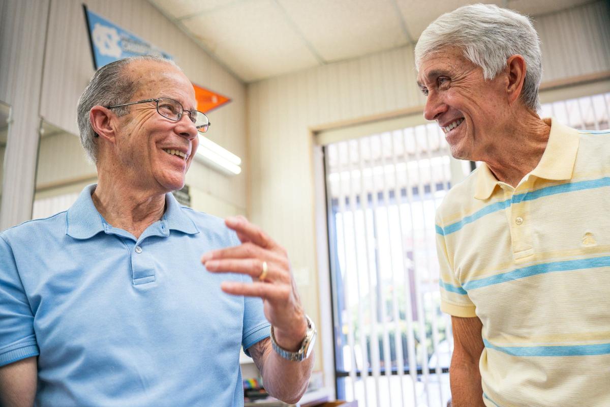 Gary Carter, left, shares a laugh with Steve James at the barbershop.