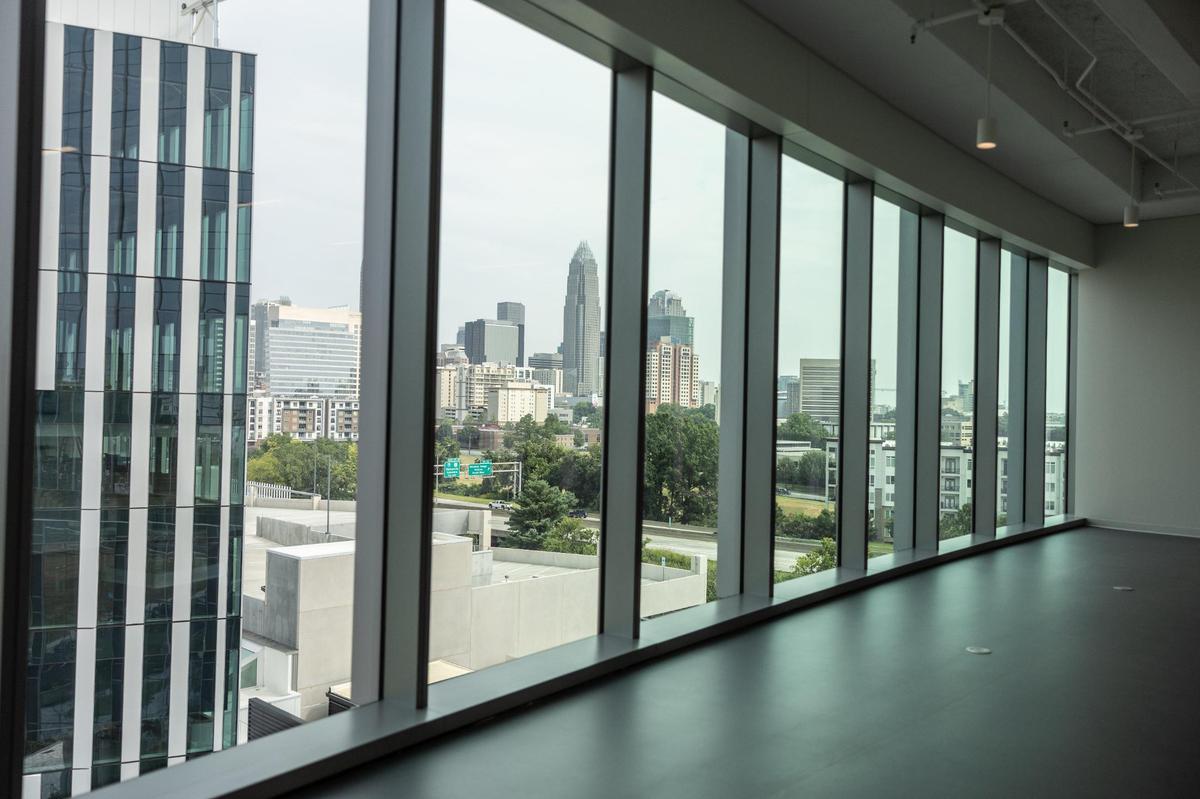 A hallway with a view of the skyline at Atrium Health Wake Forest University School of Medicine in Charlotte, N.C., on Wednesday, July 9, 2025.